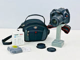 Canon EOS Rebel T3 DSLR camera with EF-S 18–55mm lens and teal camera bag