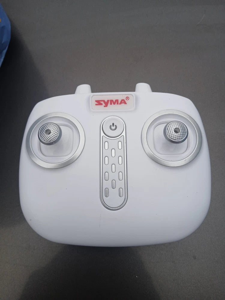 Syma white remote control transmitter with twin thumb joysticks and power button