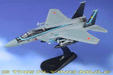 Gray F-15J fighter jet model on display stand with Japanese markings