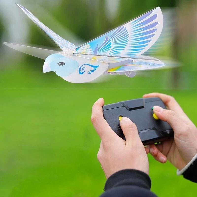 Bird-shaped mini RC drone toy with blue wings and handheld remote controller