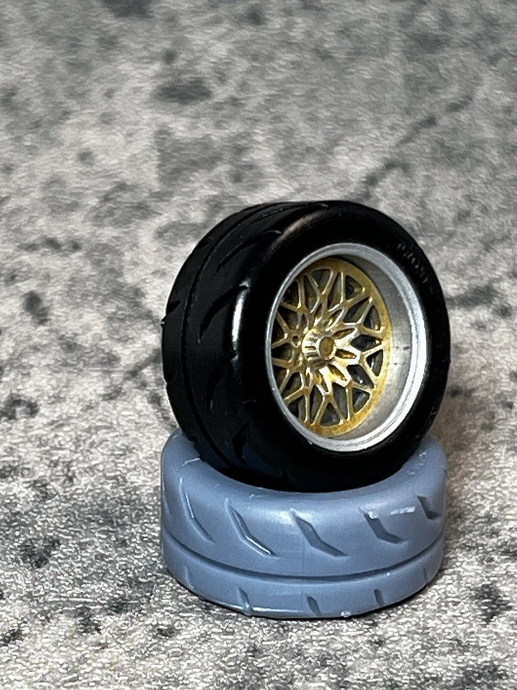 1/24 scale resin snowflake-style wheel with black tire, silver rim, gold spokes