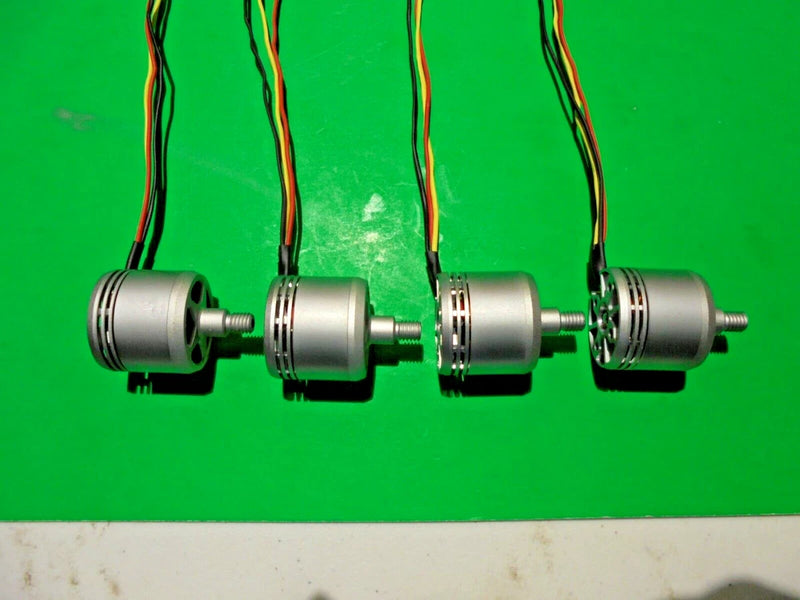 Set of four drone motor units with wiring, showing black housings and silver shafts