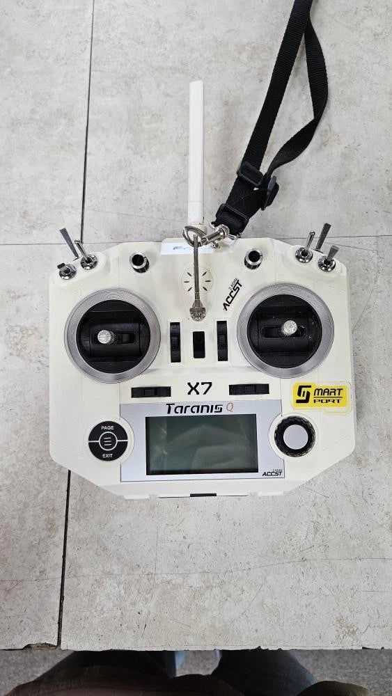 White drone controller with dual antennas, central screen, and side control knobs