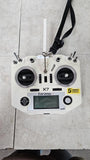White drone controller with dual antennas, central screen, and side control knobs