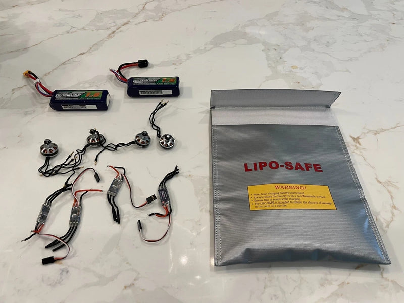 Drone battery lot with motors, ESCs, and LiPo-Safe battery bag