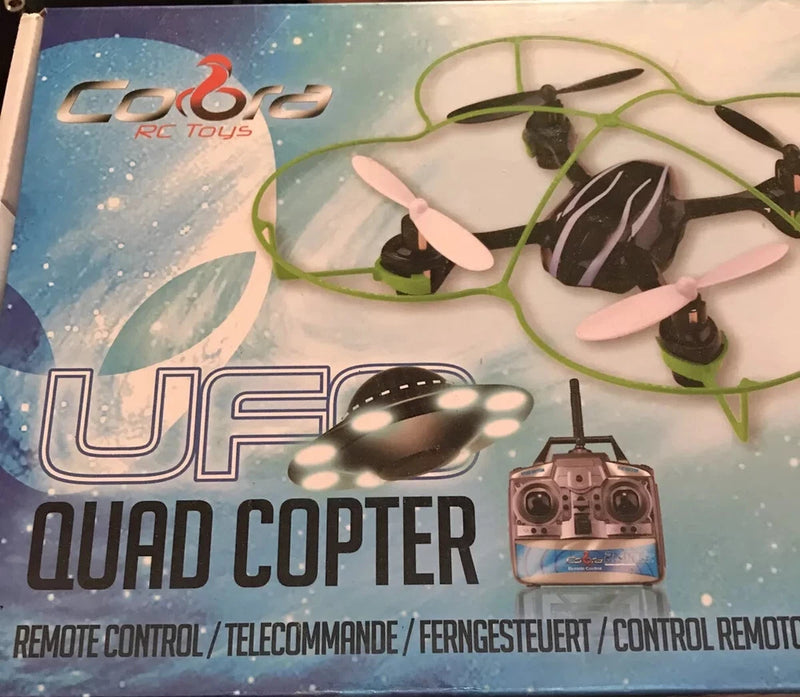 UFO quadcopter drone with green propeller guards on retail box packaging