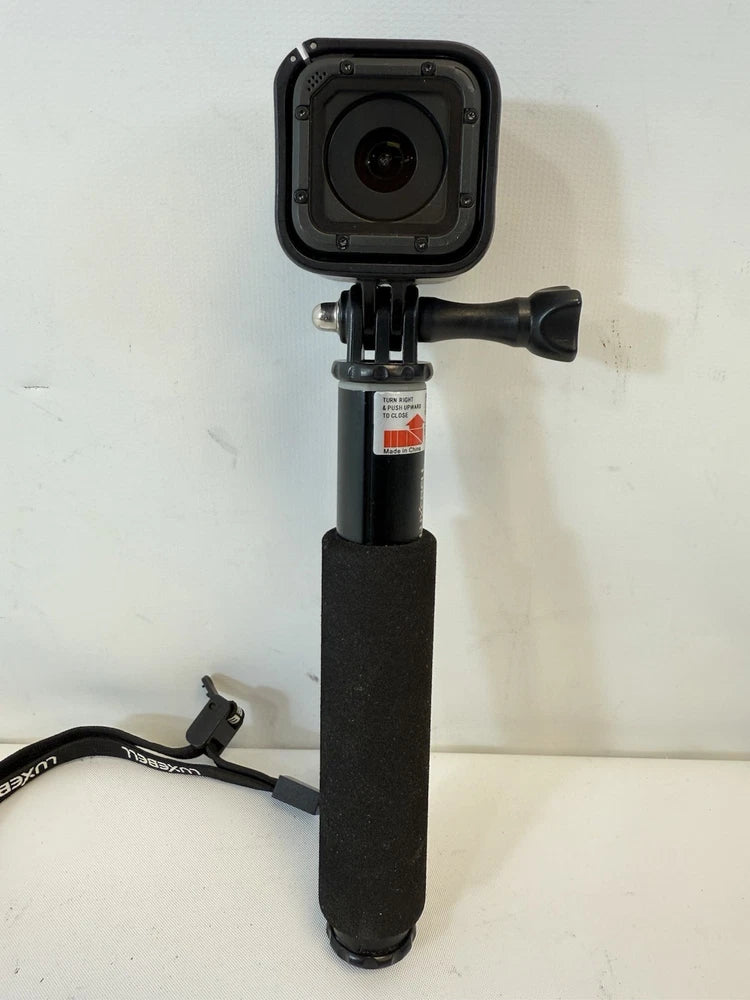 GoPro HERO4 Session action camera in black protective housing on handheld mount