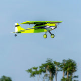 RC balsa wood airplane, green and yellow fuselage, propeller and tricycle landing gear