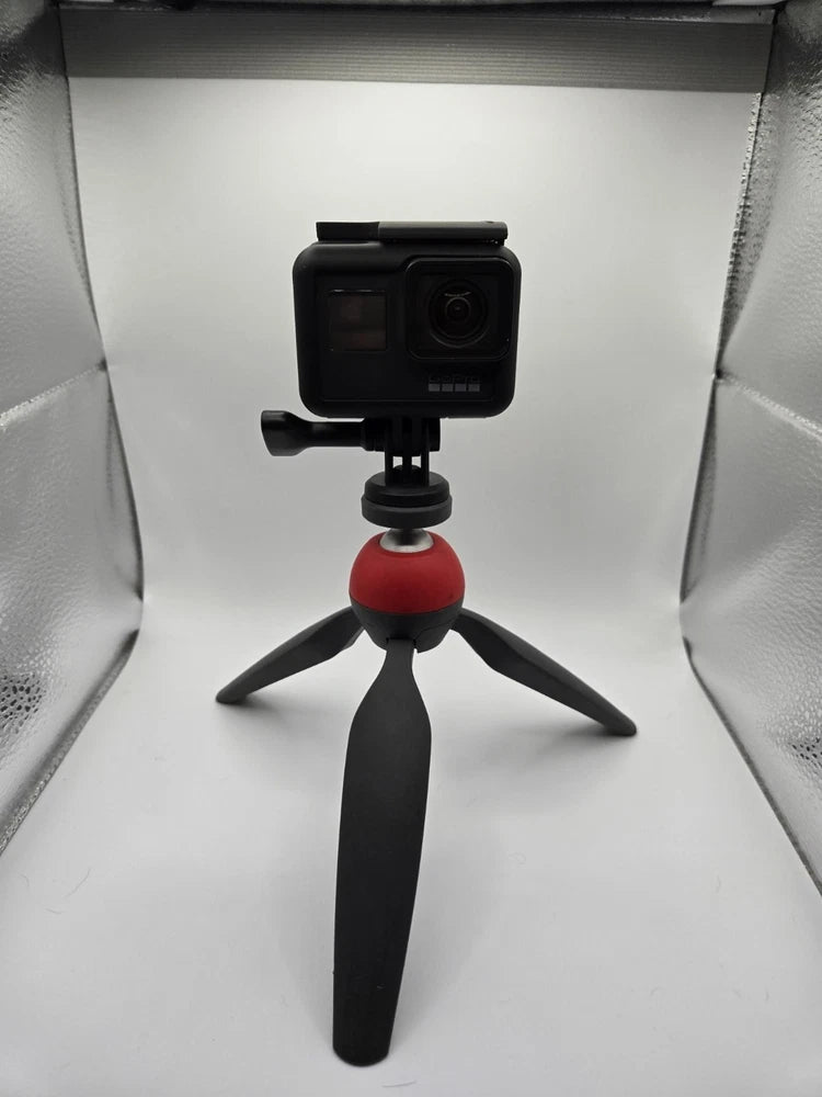 GoPro HERO7 Black action camera on tripod with red ball mount