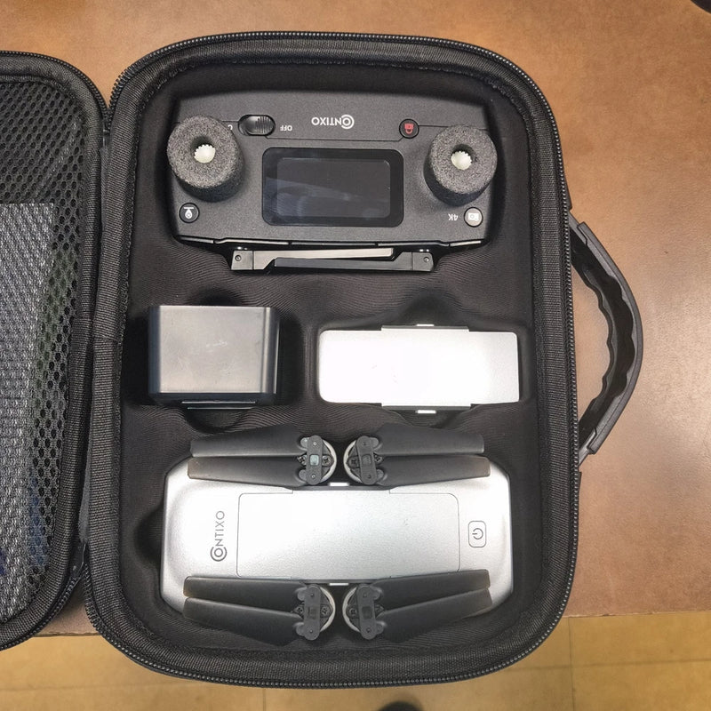 Drone in black zip carrying case with controller screen panel and storage slots