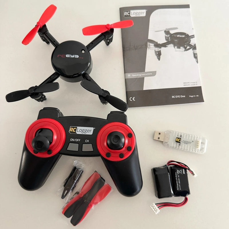 RC Logger Eye One quadcopter drone kit with black controller, red joysticks, spare props