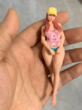 Miniature resin figurine woman with yellow hat, red hair, pink swimsuit