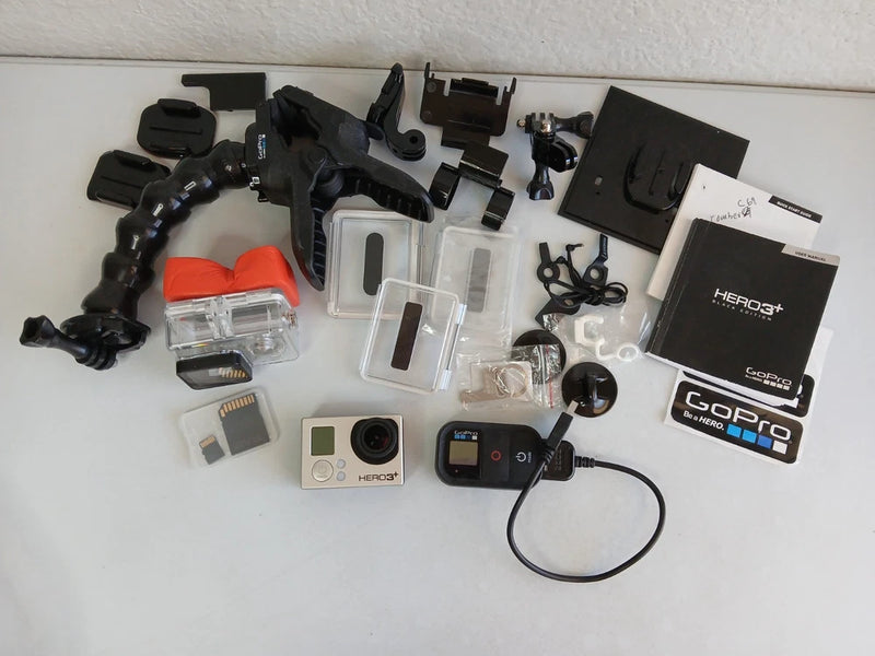 GoPro HERO 3+ Black action camera kit with mounts, cases, batteries, and cables