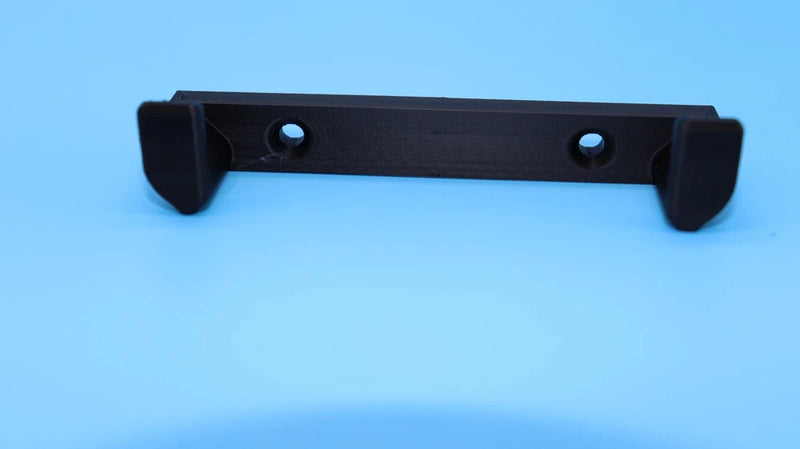 Black FPV drone wall mount bracket with screw holes