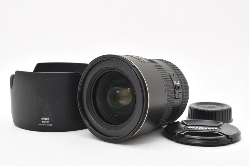 Nikon AF-S DX 17-55mm F2.8G ED camera lens with black hood and caps