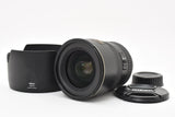 Nikon AF-S DX 17-55mm F2.8G ED camera lens with black hood and caps