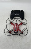 Palm-sized RC drone in black and red with visible propellers, top view