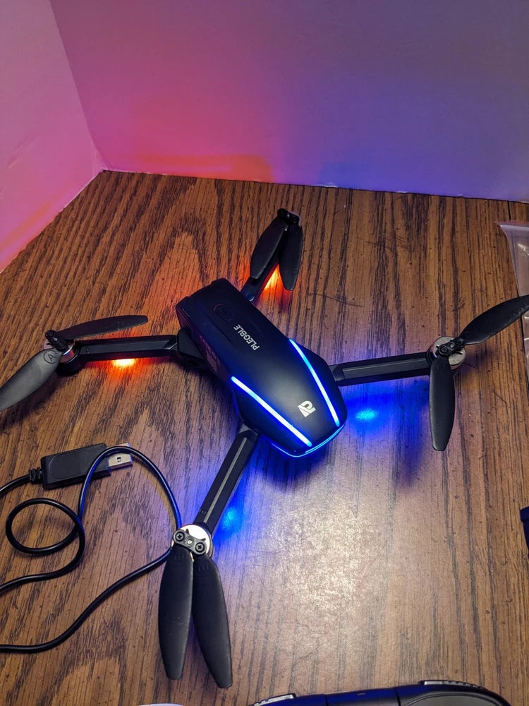 Foldable 4K camera drone with blue LED lights and four propellers, dark gray body