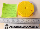 Yellow light-up battery hub part with central holes and switch contacts
