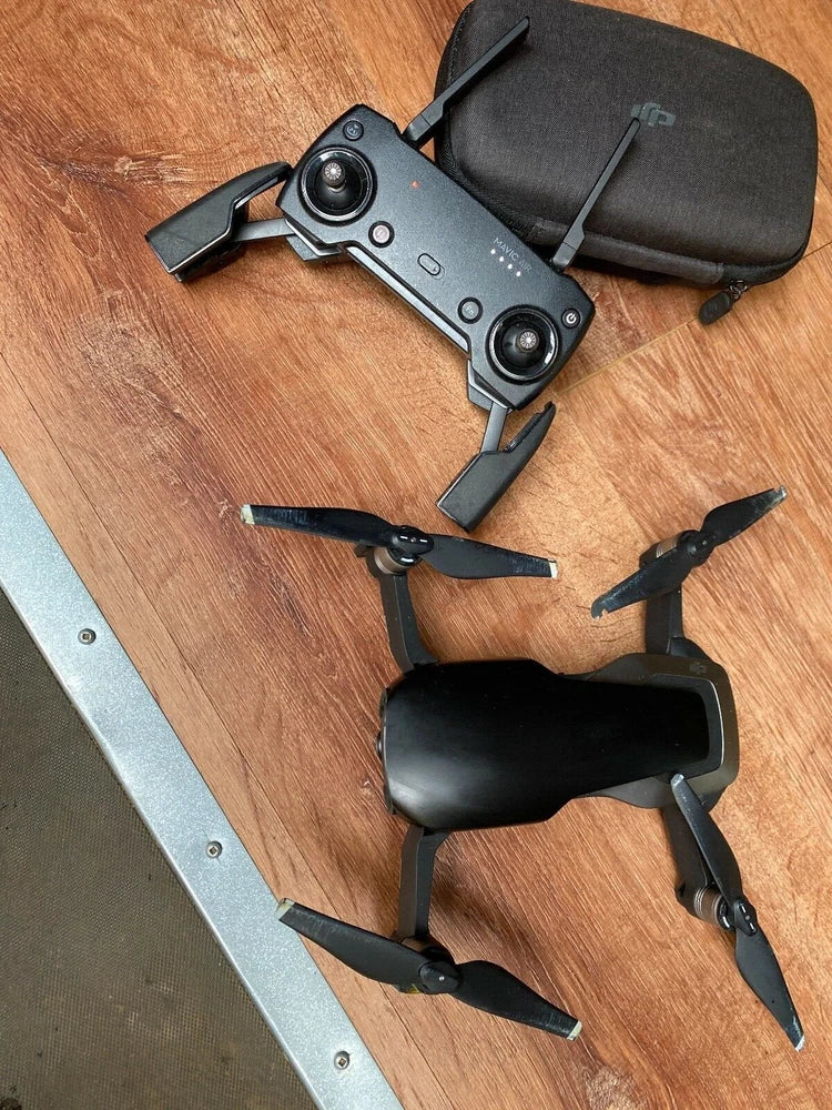 Foldable quadcopter drone with four propellers and black storage case