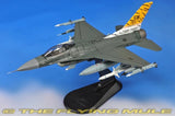 Gray F-16C fighter jet model with orange tiger tail, mounted on black display stand