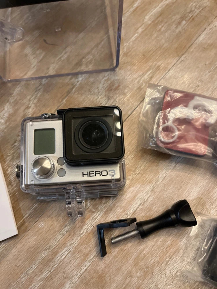GoPro HERO3 Silver action camera in clear waterproof housing with mount hardware