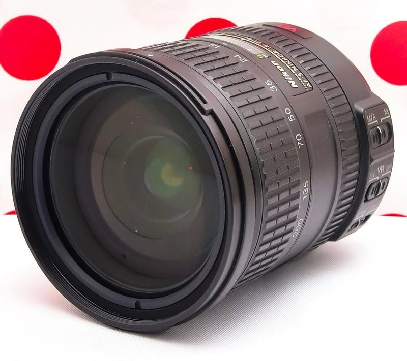 Nikon DX zoom lens with 18-200mm barrel and VR markings, front element visible
