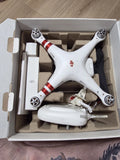 DJI Phantom 3 quadcopter drone in open box with controller and prop guards