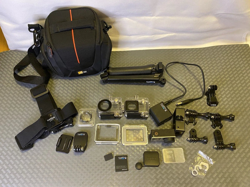 GoPro HERO4 action camera kit with carry case, mounts and selfie stick, assorted accessories