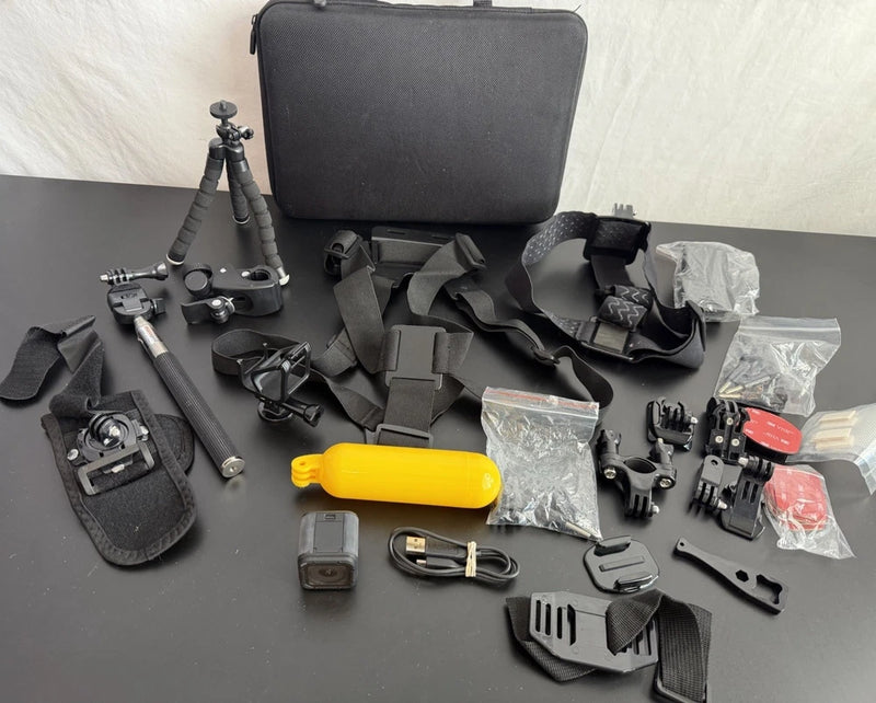 Black action camera accessories case with selfie stick, mounts, and cables