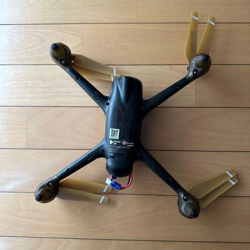 Quadcopter drone with four propeller arms and dark body
