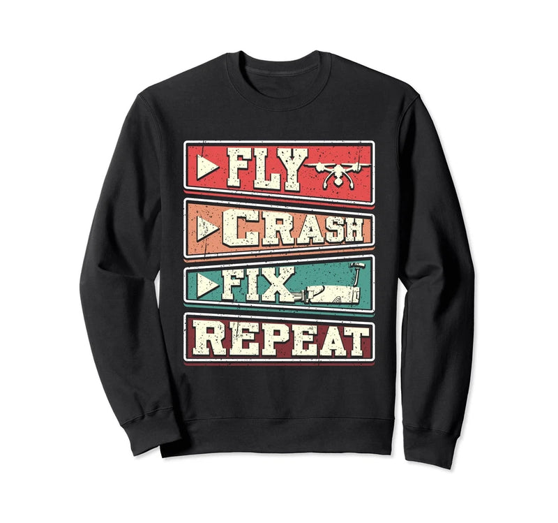 Black graphic sweatshirt with bold 'FLY CRASH FIX REPEAT' lettering