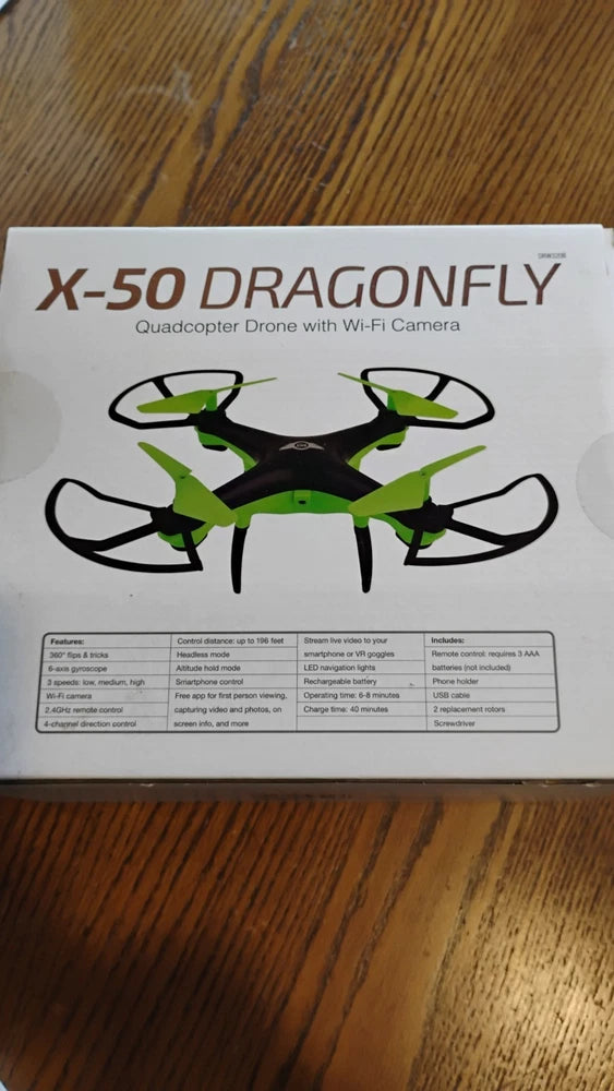 Green and black quadcopter drone with four propellers and Wi‑Fi camera on a box