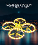 Mini yellow quadcopter drone with glowing LED rings and four propellers