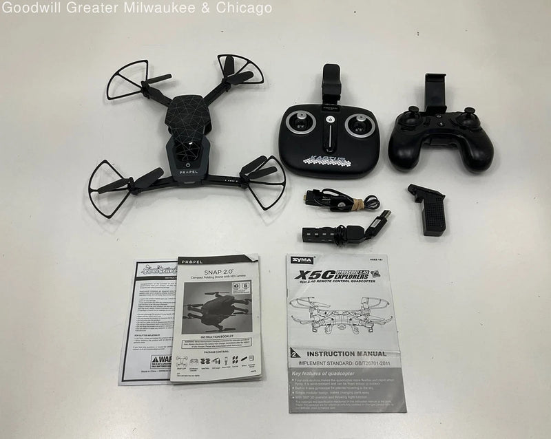 Quadcopter drone with remote controller and instruction manuals, black