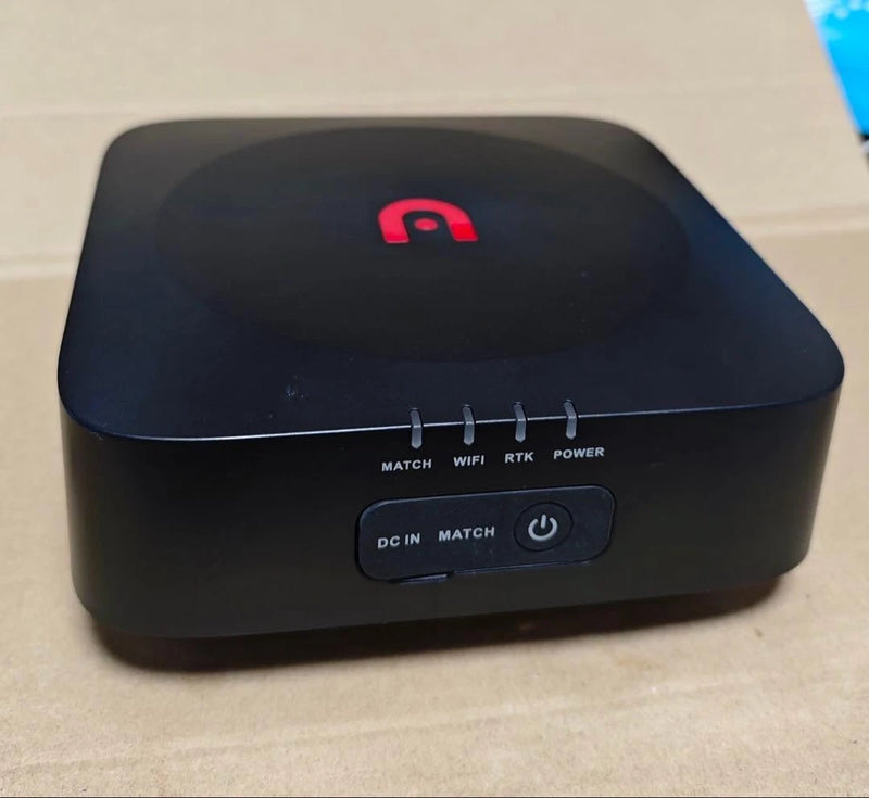 Drone ground control station, dark tabletop unit with red logo and control buttons