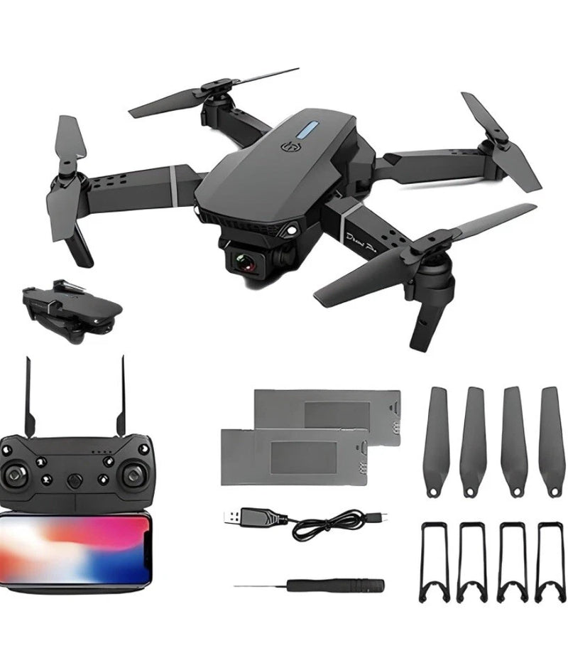 Foldable gray 4K quadcopter drone kit with controller, props, and spare parts.