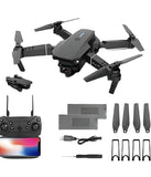 Foldable gray 4K quadcopter drone kit with controller, props, and spare parts.