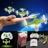 Green mini quadcopter drone with LED lights and remote controller