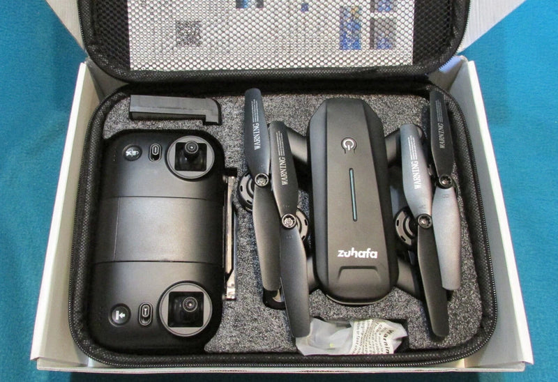Foldable FPV drone with controller, propellers, and carrying case.