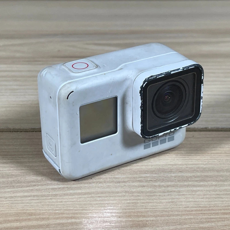 White rugged action camera with front lens and side screen window, red power button