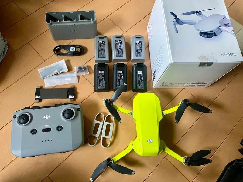 Dji Mini 2 drone kit with controller, four batteries, and battery charger