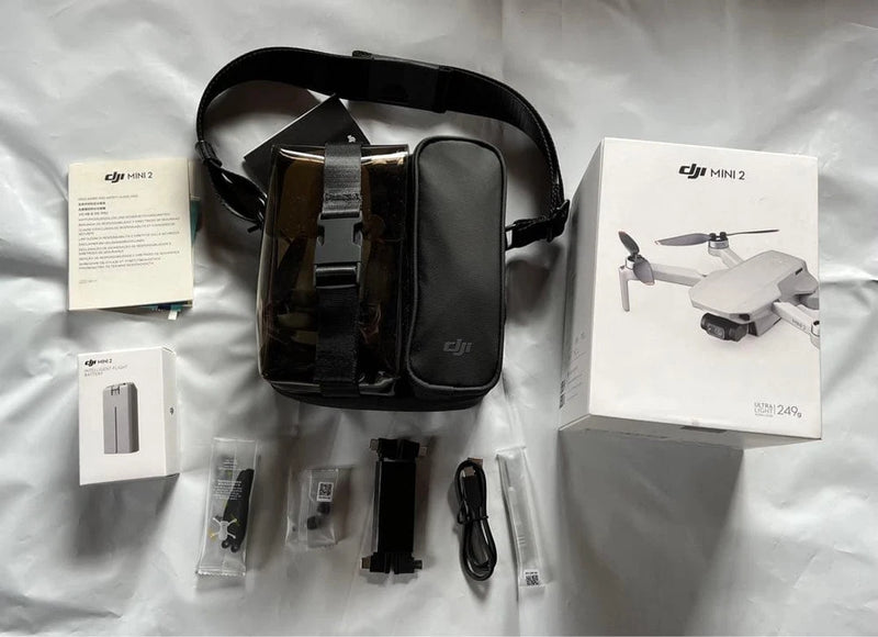 DJI Mini 2 drone kit with black carrying case and accessories, including propellers