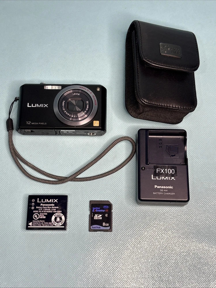 Black Panasonic Lumix digital camera kit with leather case, strap, battery charger, cards