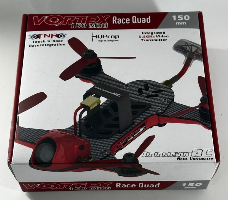 Red and black mini race quad drone with four propellers, shown on retail box