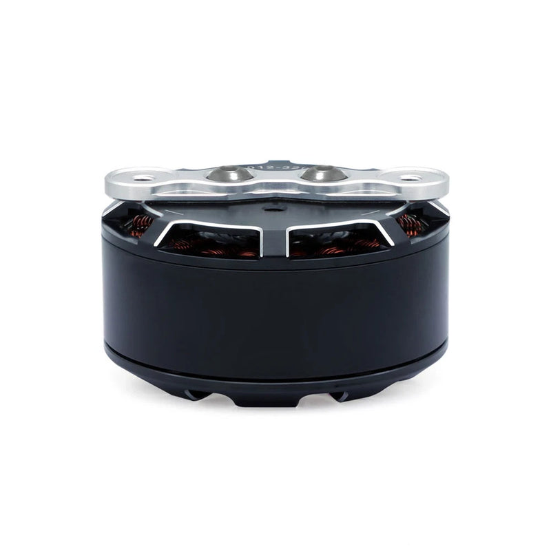 Drone motor with black cylindrical housing and silver top plate, visible copper windings