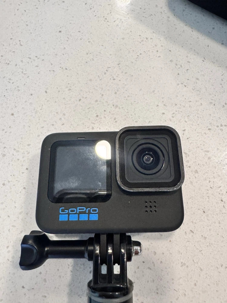 Black GoPro HERO action camera with waterproof touchscreen and front lens, on mount