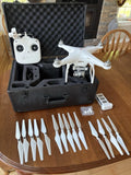 White DJI Phantom 3 drone with controller and extra prop blades in hard case