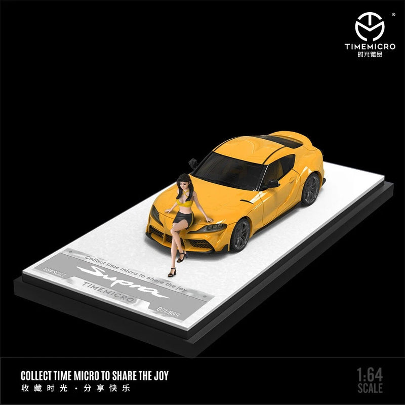 Yellow die-cast 1:64 model car with doll figure, on display base