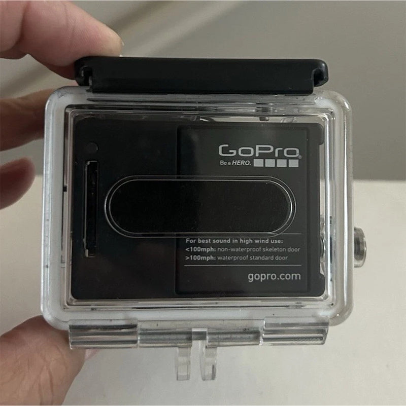 GoPro HERO3 action camera in clear waterproof housing, black rear door with logo